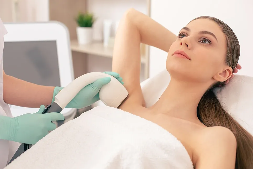 Woman receiving underarm laser hair removal