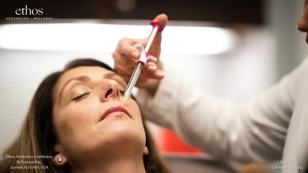 Mature woman receiving a filler injection near the upper lip