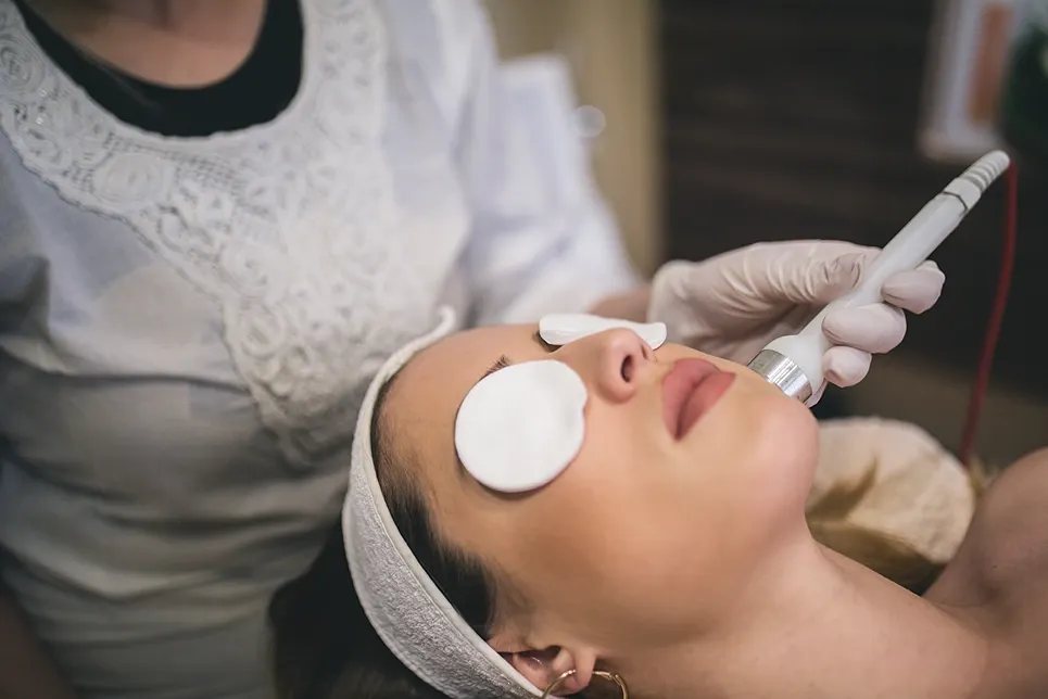 Upper lip and chin laser treatment on a woman with eye pads