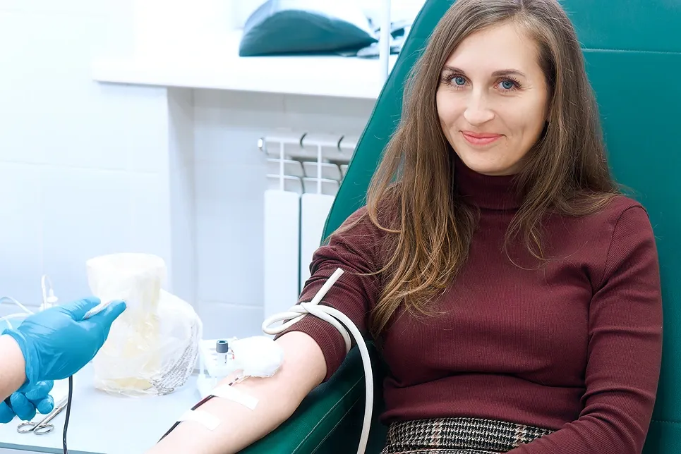 Smiling woman relaxing during an IV drip