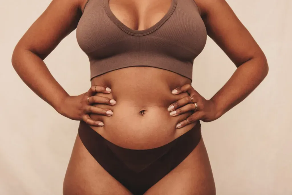 Woman wearing brown underwear against a studio background
